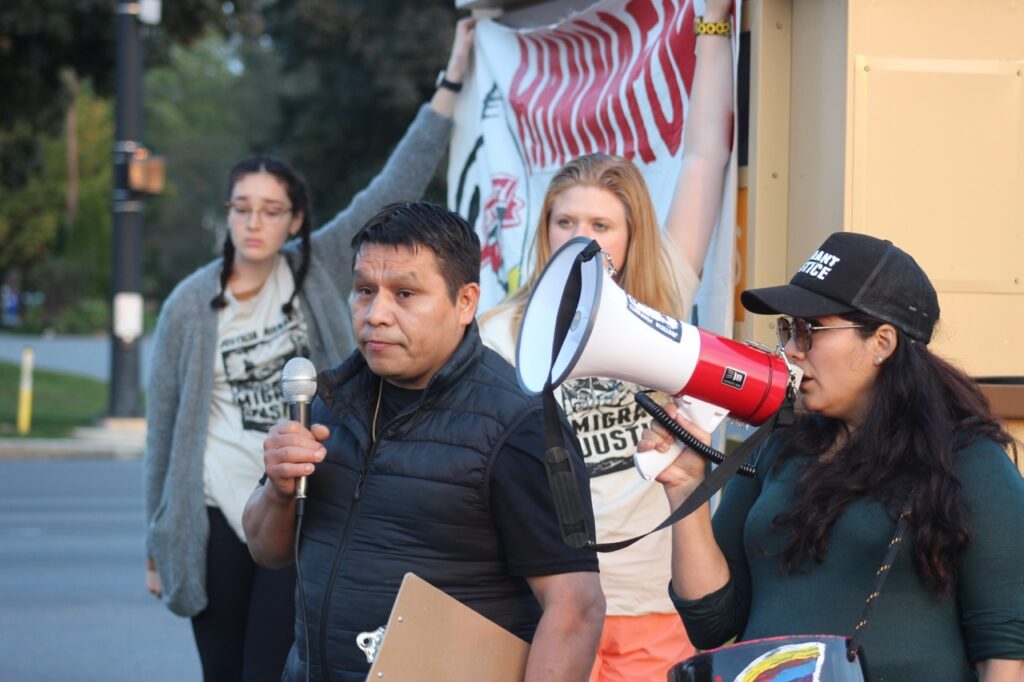 Dairy farmworker Jesús speaks to the assembled crowd outside Hannaford in South Burlington.