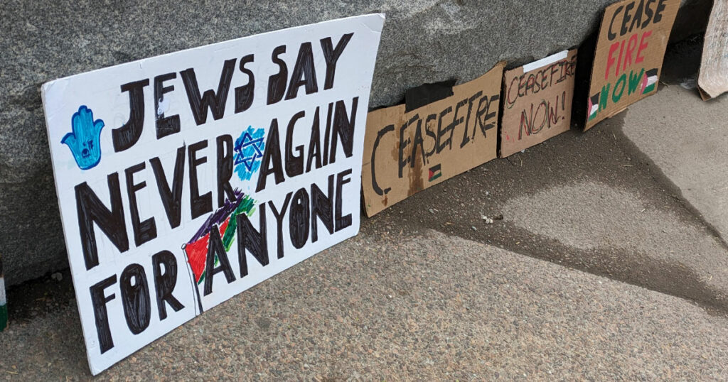 Sign that reads Jews say never again for anyone